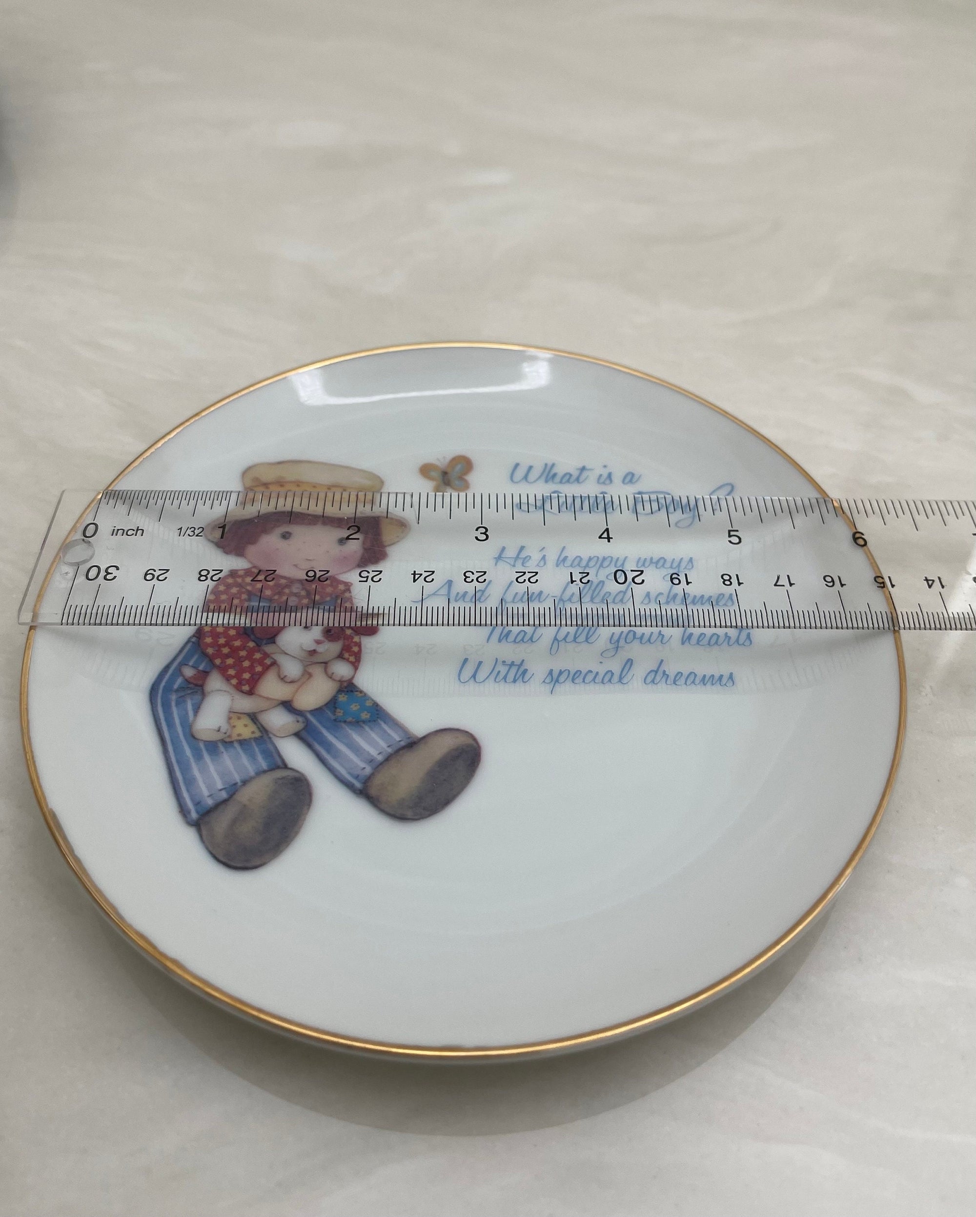 What is a Little Boy Decorative Plate on Brass Easel